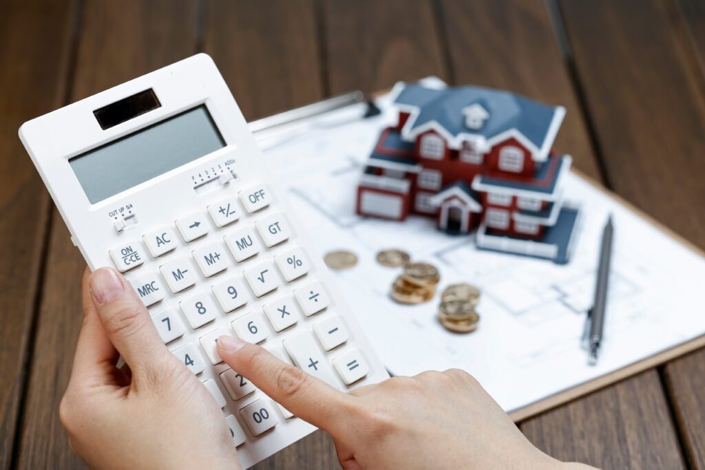 female-hand-operating-calculator-front-villa-house-model-1024x683
